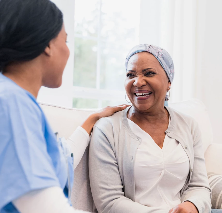 Senior woman smiling at caretaker.