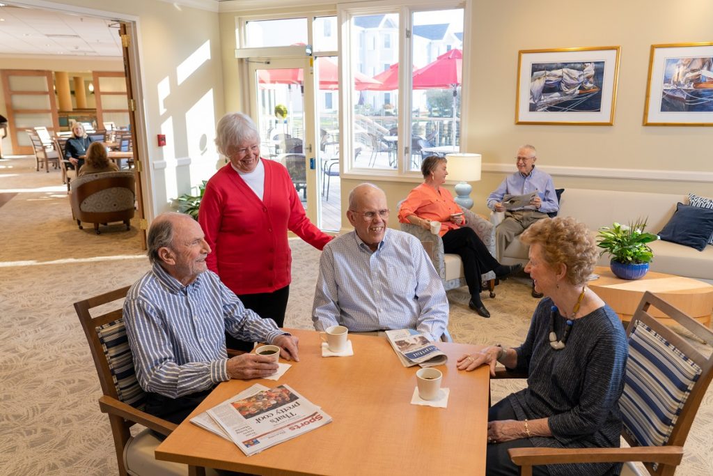 Group of Ginger Cove residents with coffee sitting around table