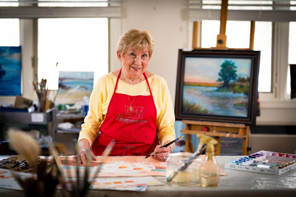 Ginger Cove artist posing with her paintbrush