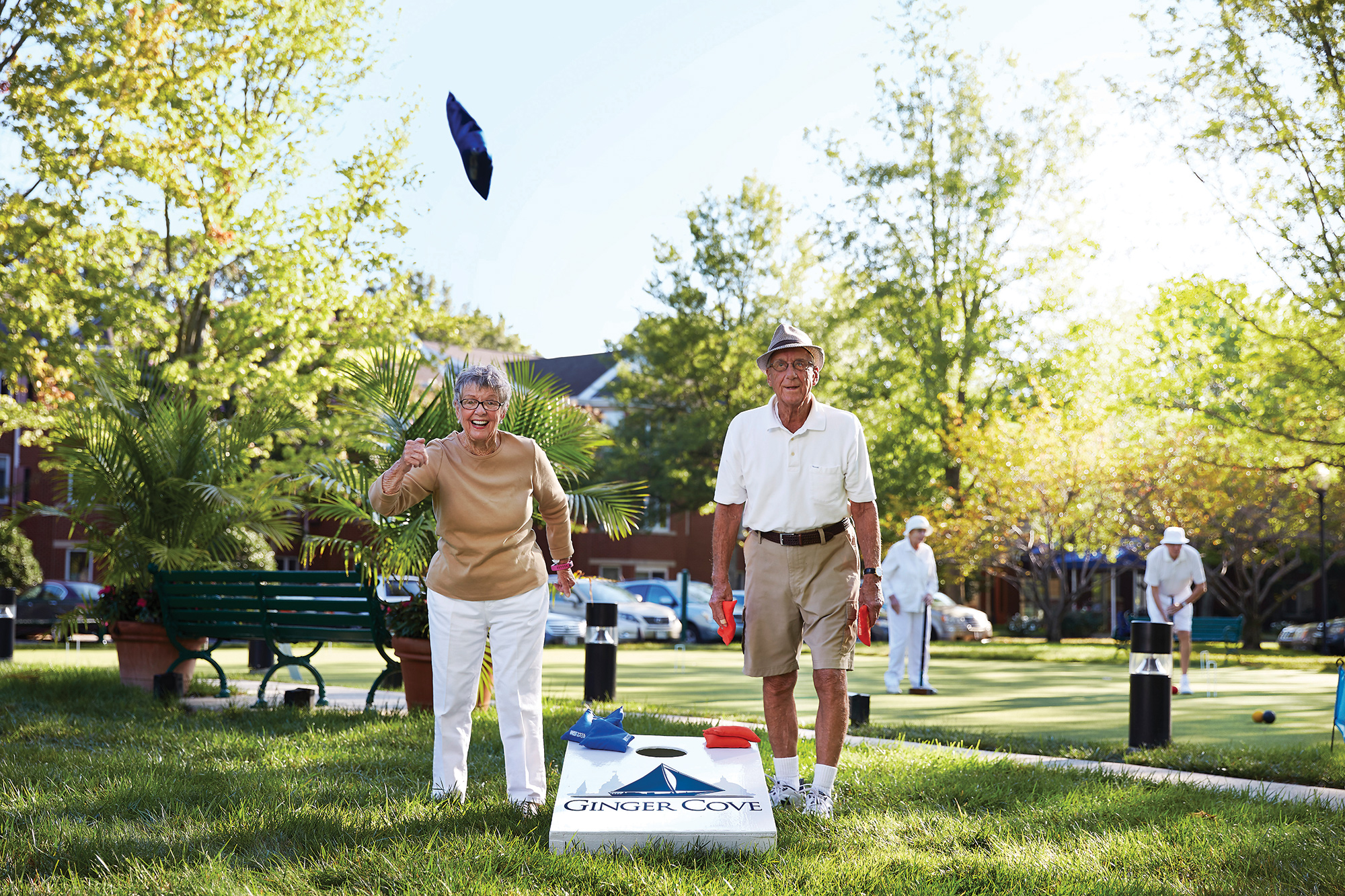Couple playing cornhole at Ginger Cove
