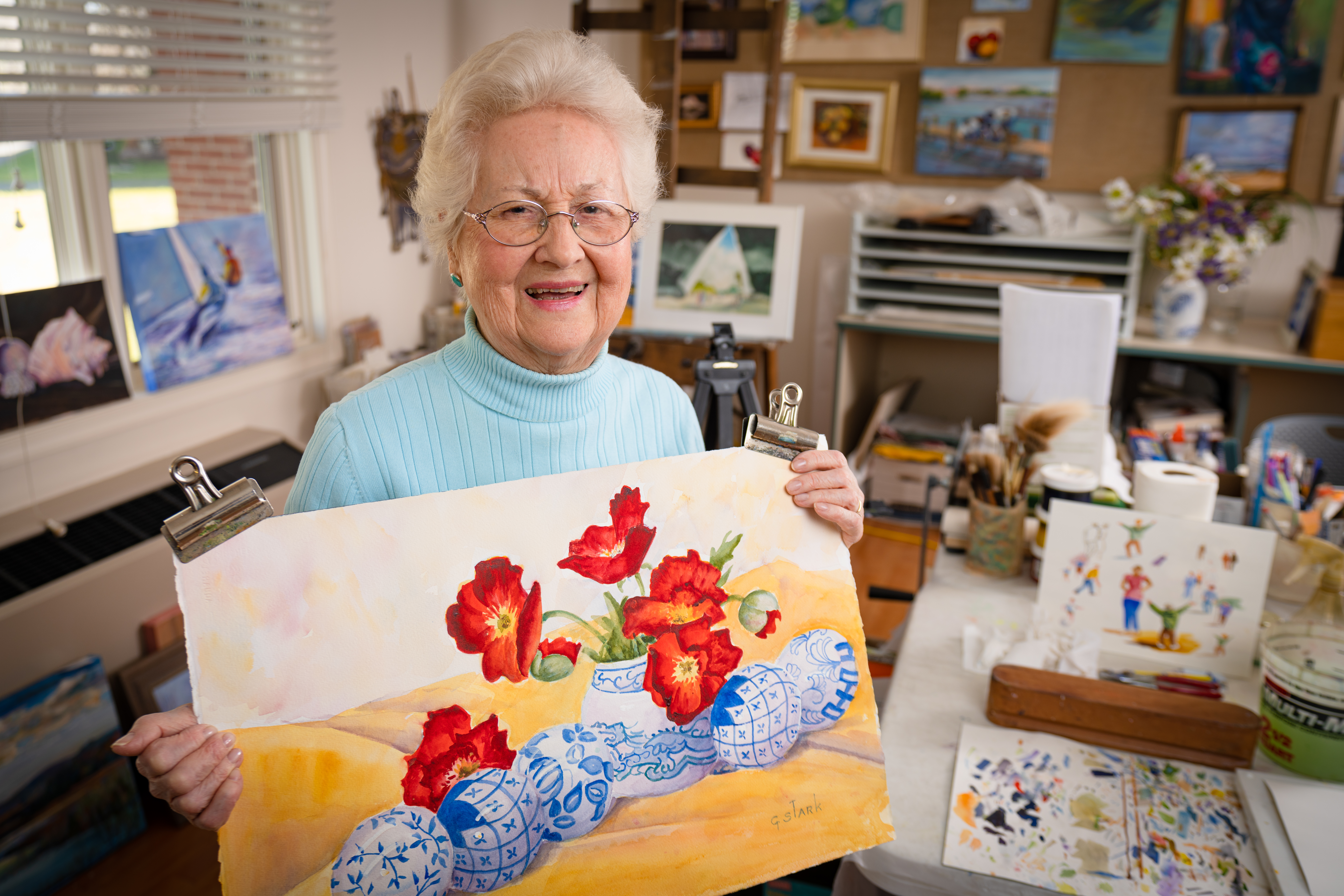 Senior resident showcasing painting.