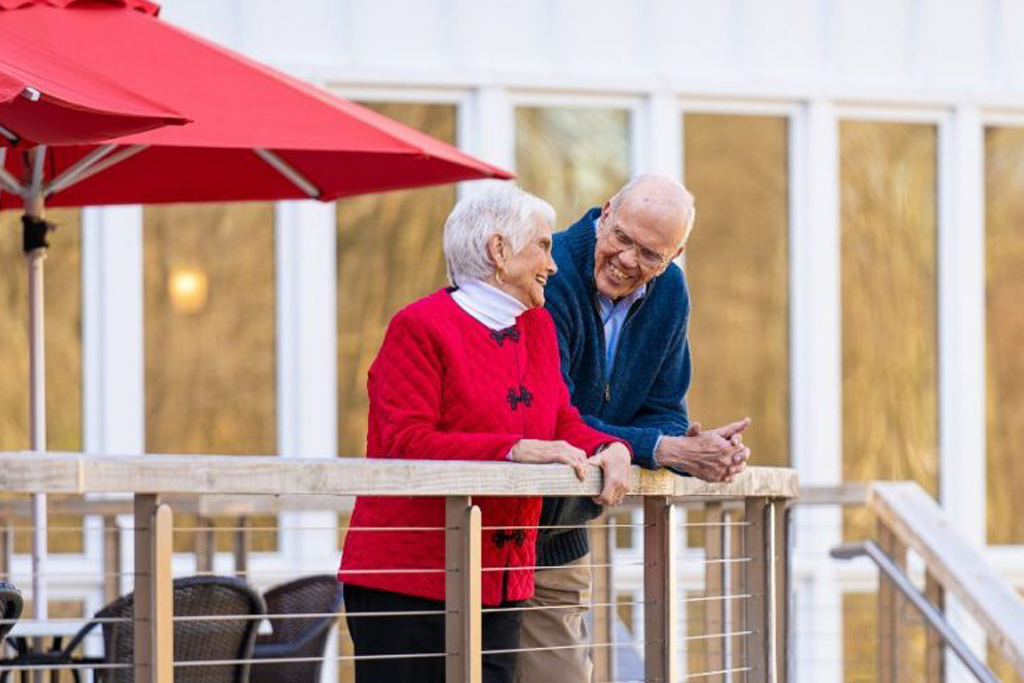 Ginger Cove residents on outdoor patio smiling