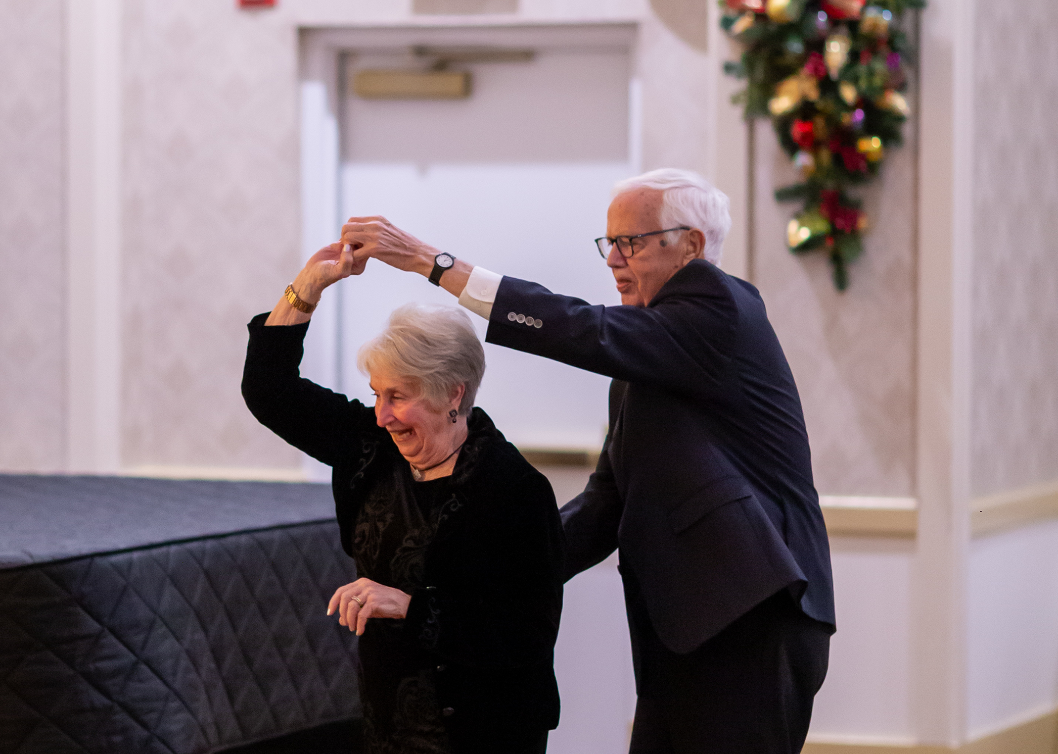 Senior couple dancing at Christmas celebration at Ginger Cove in Annapolis, MD