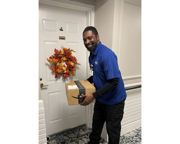 Ginger Cove employee delivering packages to residents