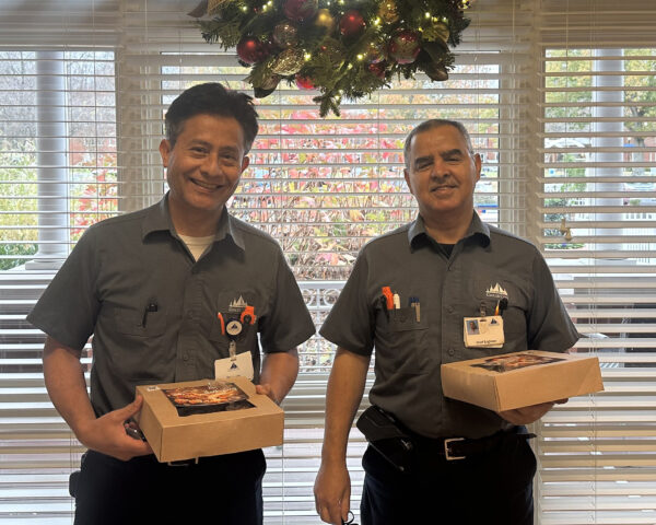 Ginger Cove engineers smiling and holding pies